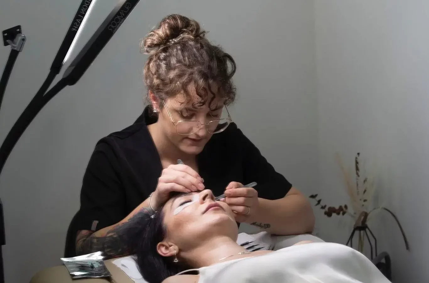 Client getting eyelash extension treatment in Cambridge