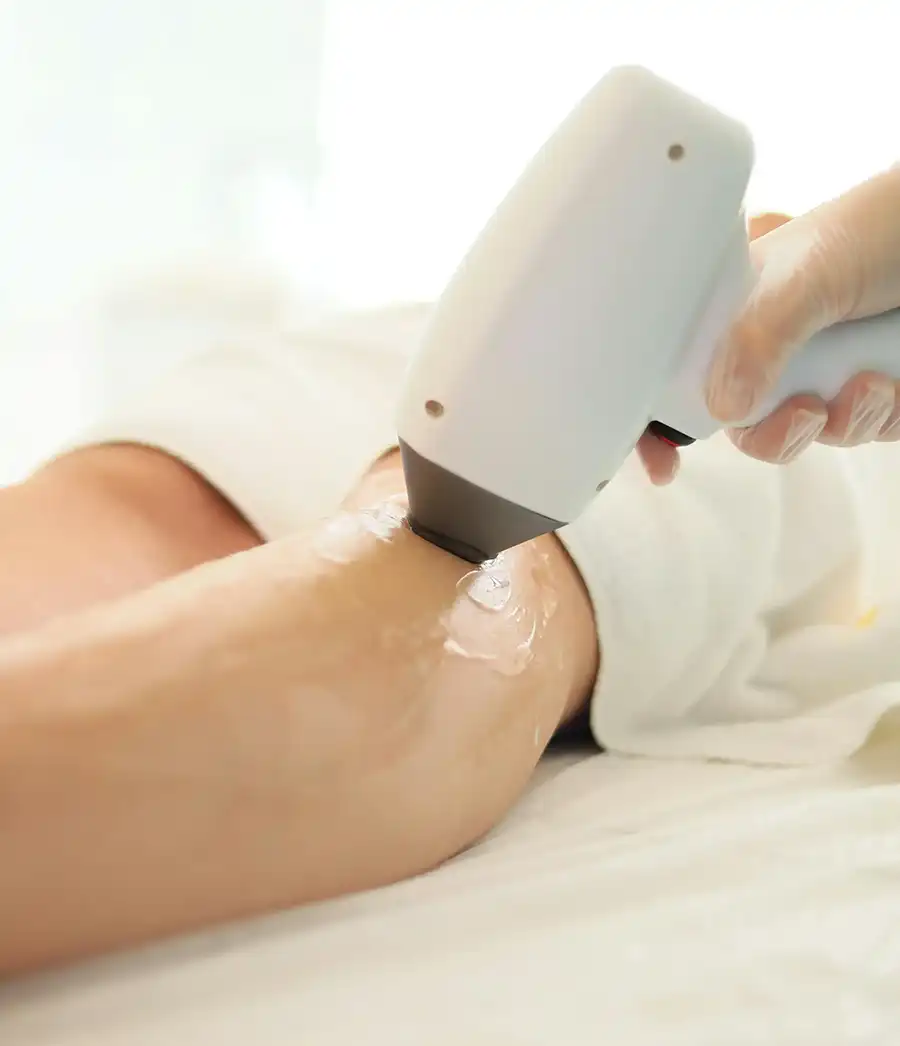 Woman smiling and touching her smooth skin after laser hair removal treatment